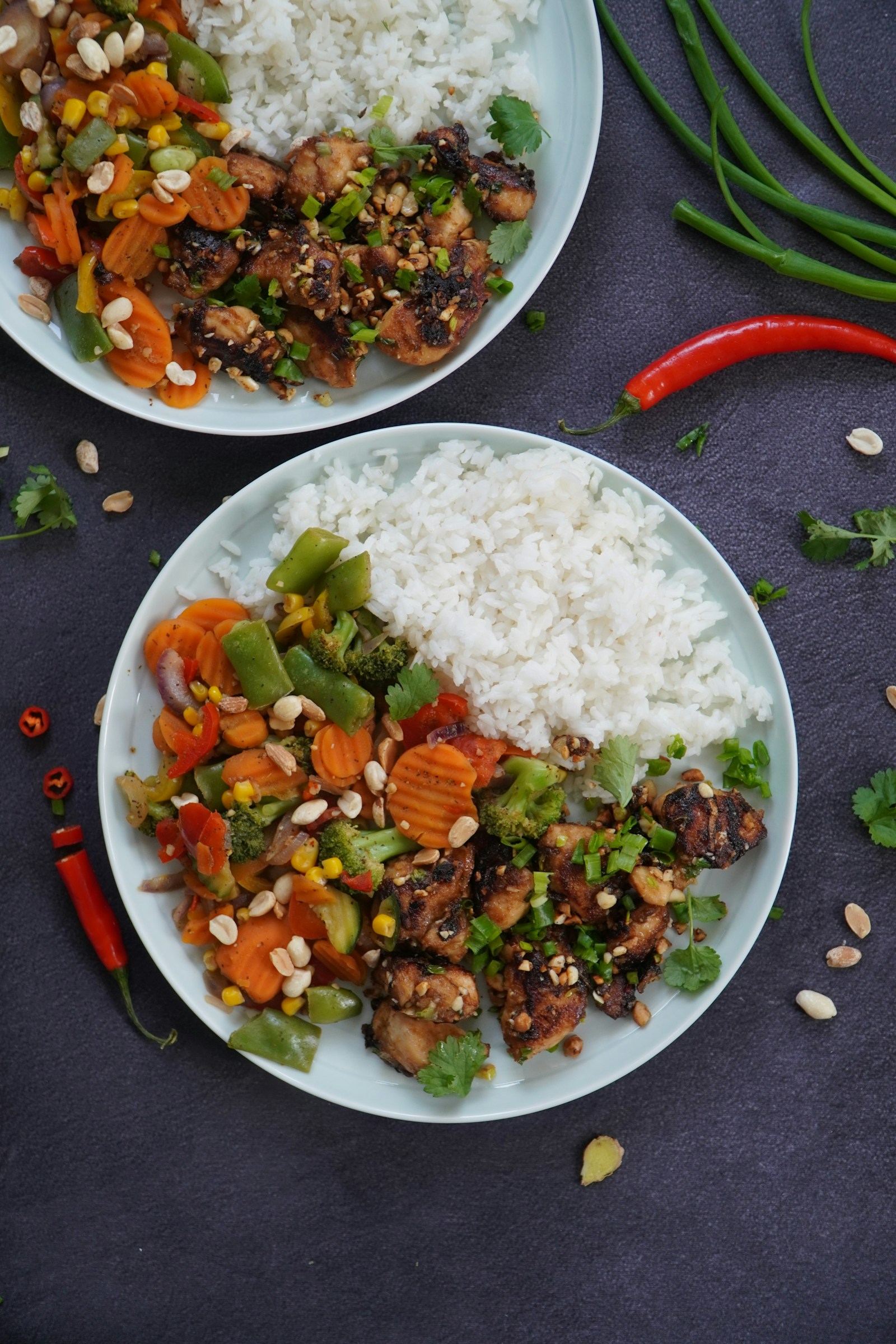 Chicken, rice and vegetables on a dark tabletop